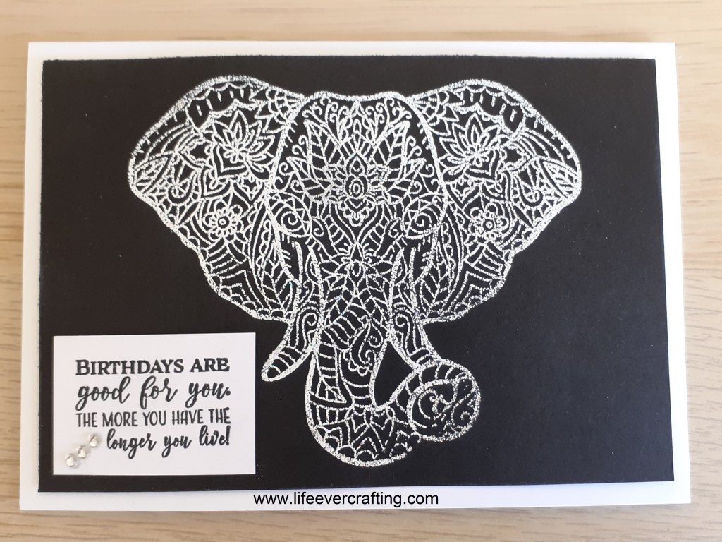 The image shows a zentangle elephant outlined in white on a black background. There is a sentiment in the bottom left corner which reads Birthdays are good for you. The more you have the longer you live!