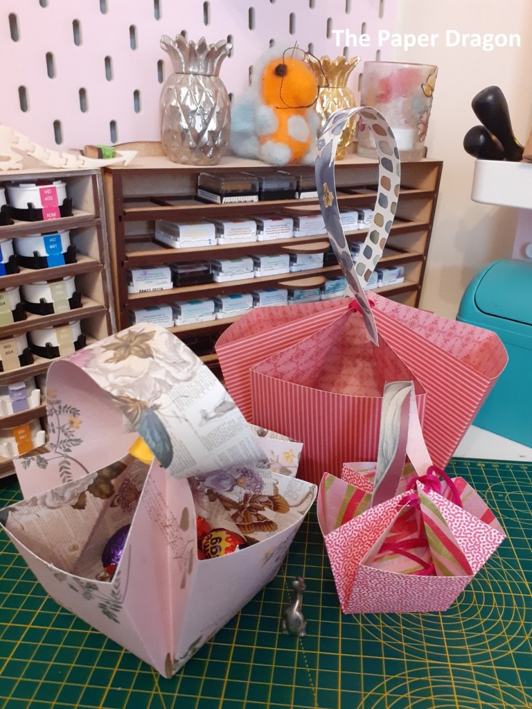 image shows three baskets made from paper in different sizes.